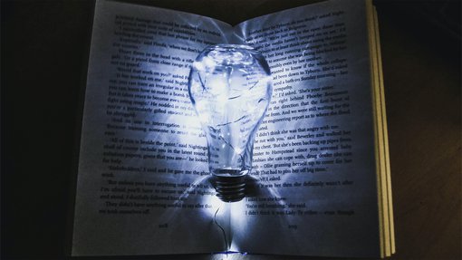 Image of a lightbulb on a book. Ways to Boost Your Imagination and Unleash Your Creativity