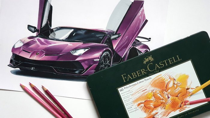 Image of a car drawing made with oil based colored pencils next to a box of oil based faber catsell polychromos colored pencils